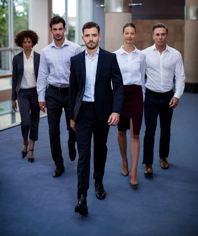 Portrait of business executives walking in a conference center lobby Portrait of business executives walking in a conference center lobby